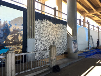 Photo of a local urban artist painting a mural under the I-70 viaduct during the 'duct-work Event (September 30, 2016).